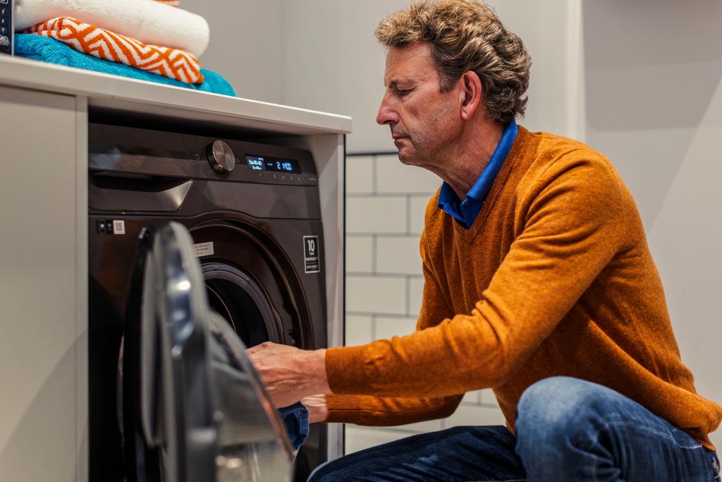 Man loading washing machine